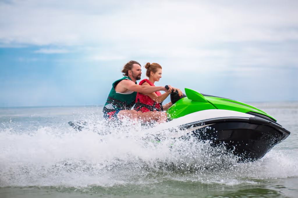 young people having fun driving high speed water scooter man woman summer vacation friends doing active sport